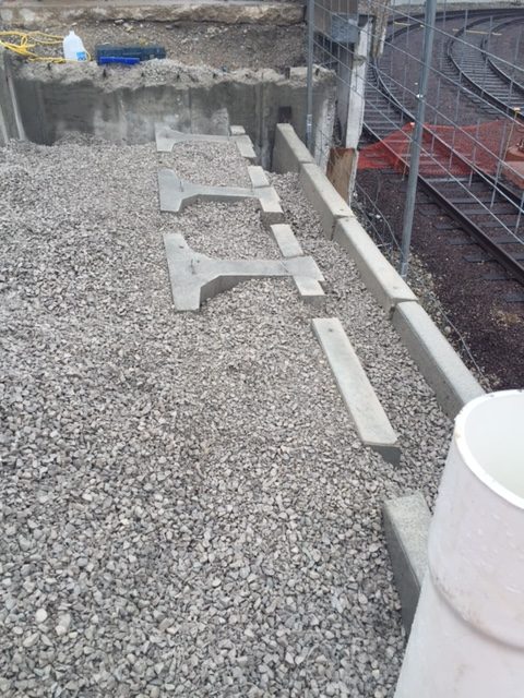 Retaining wall block using extenders near the top of the wall